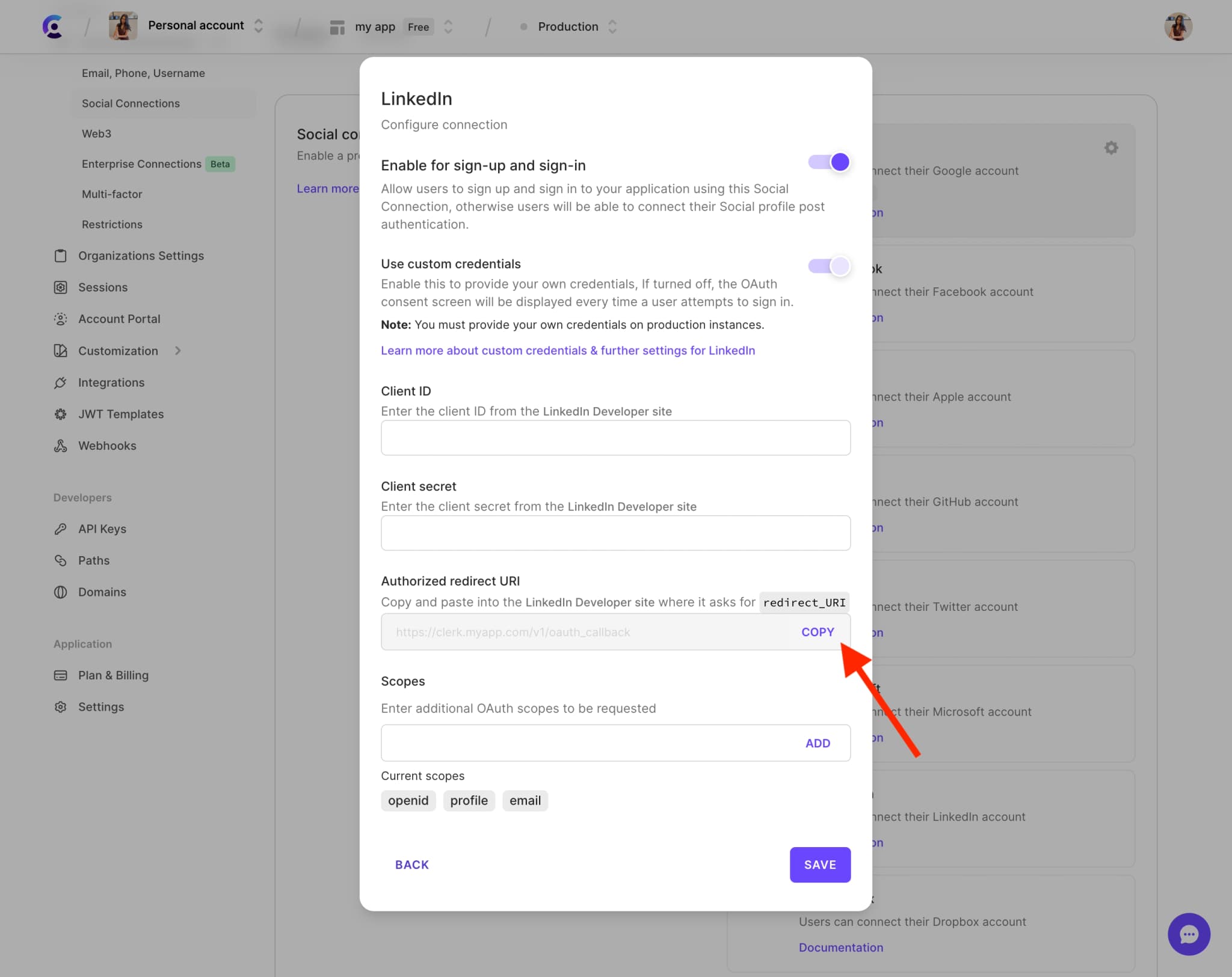 The LinkedIn settings modal in the Clerk Dashboard. A red arrow is pointing to the 'Redirect URI' copy button.